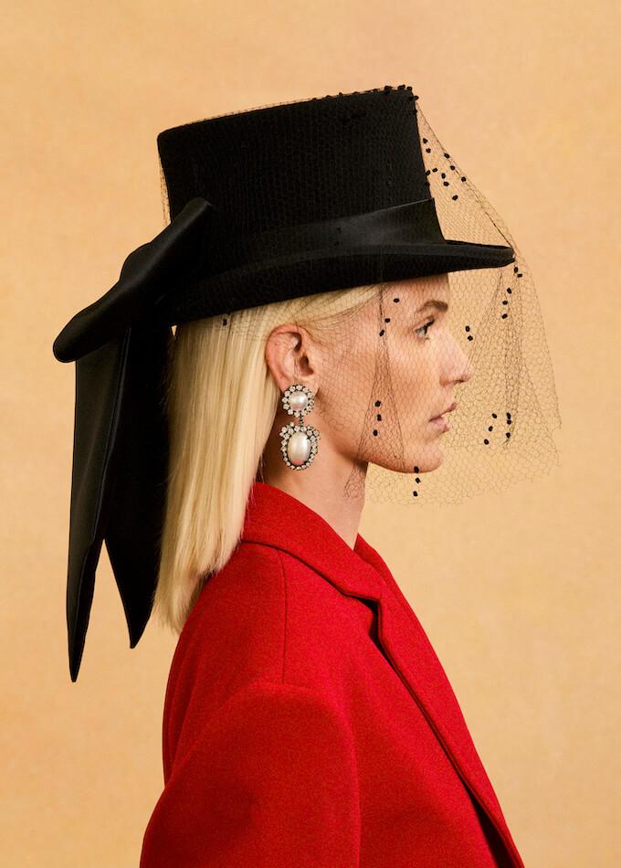 Black top hat with veil and oversized silk bow