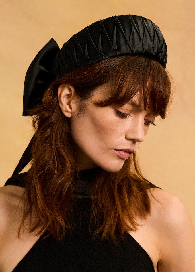 luxury black pleated headpiece with a bow